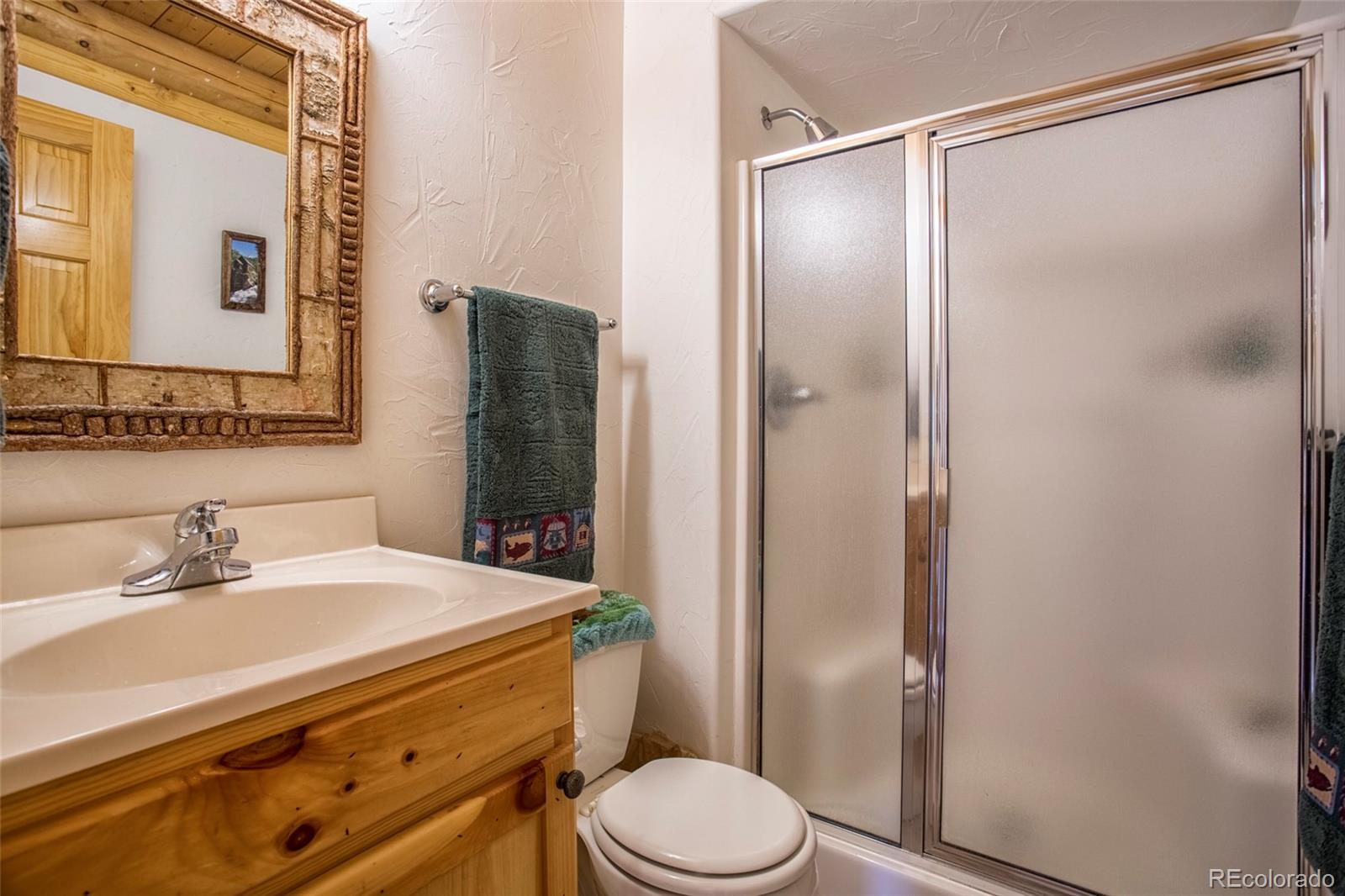 144 Red Cloud Road Como, CO 80456 - Photo 18 of 34 a bathroom with a sink a toilet and shower