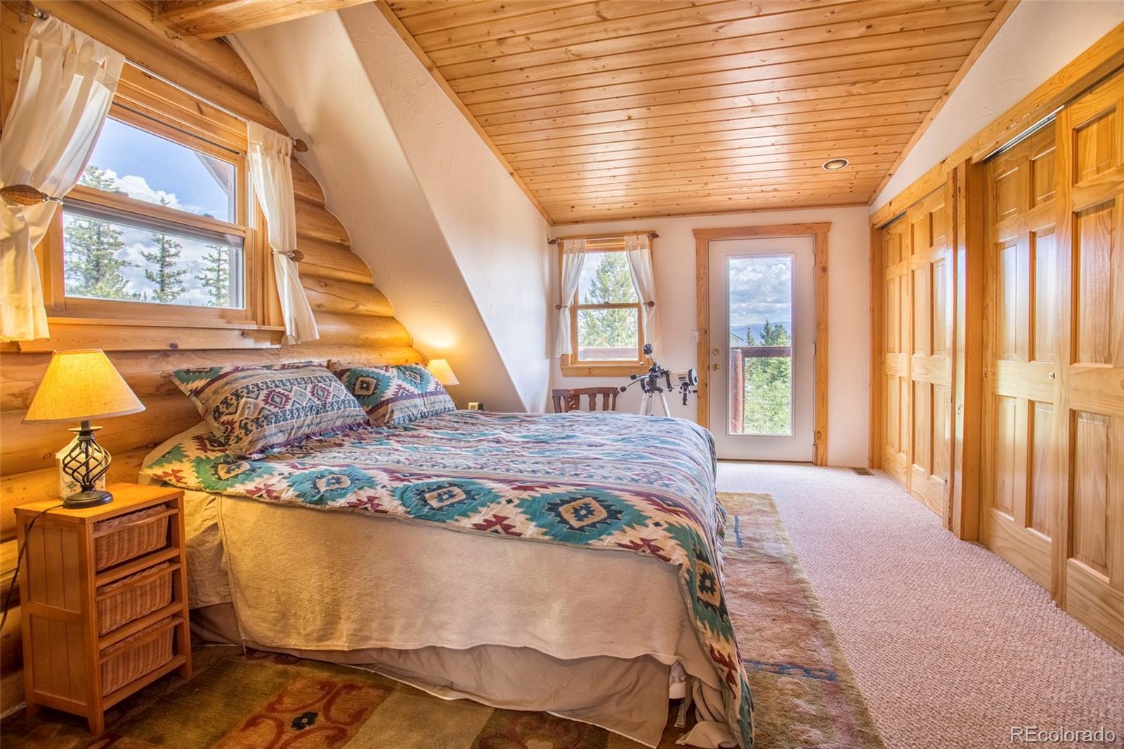144 Red Cloud Road Como, CO 80456 - Photo 21 of 34 a spacious bedroom with a bed and wooden floor