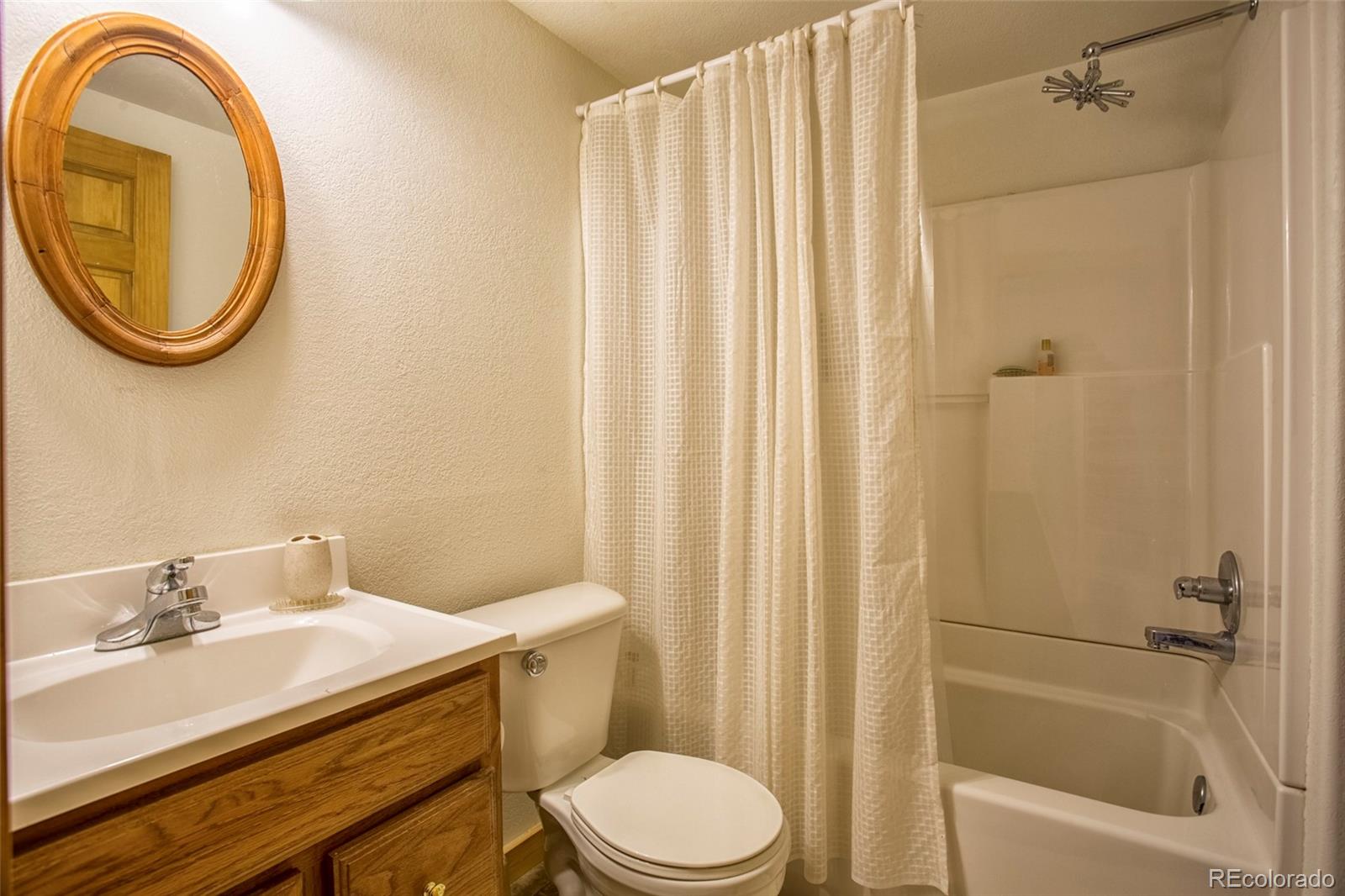144 Red Cloud Road Como, CO 80456 - Photo 23 of 34 a bathroom with a sink a toilet and a mirror