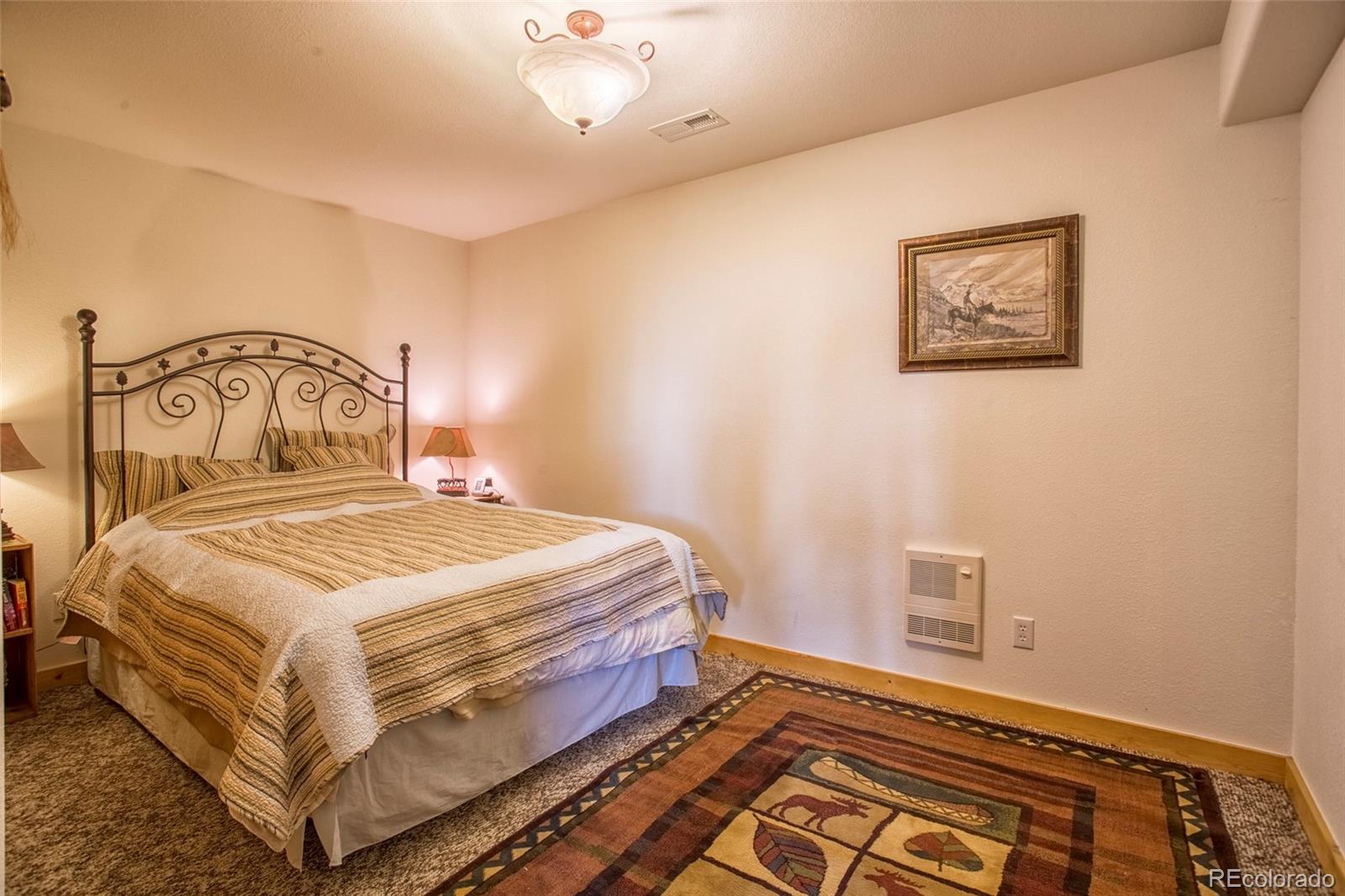 144 Red Cloud Road Como, CO 80456 - Photo 24 of 34 a bedroom with a bed and wooden floor