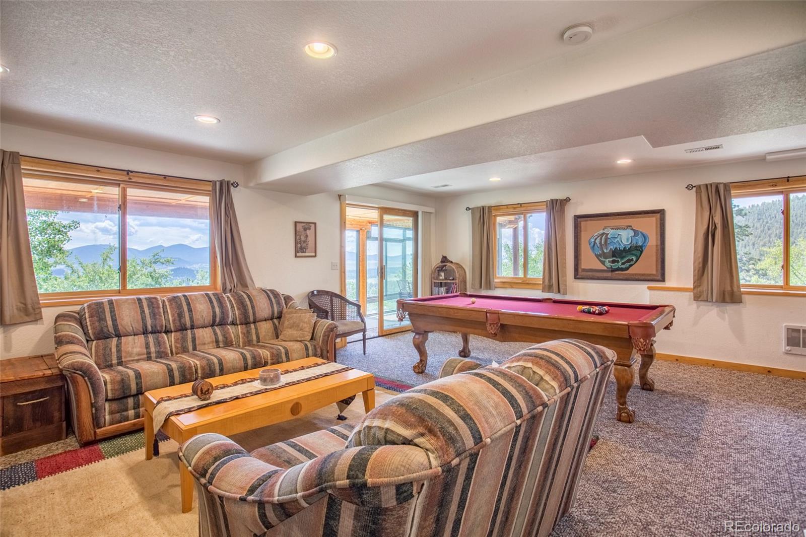 144 Red Cloud Road Como, CO 80456 - Photo 26 of 34 a living room with furniture a couch and two large window