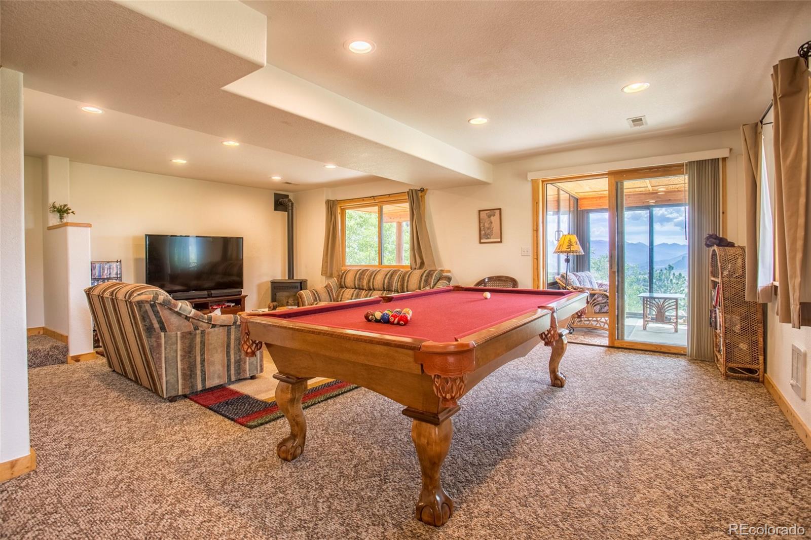 144 Red Cloud Road Como, CO 80456 - Photo 27 of 34 a living room with furniture a flat screen tv and a large window