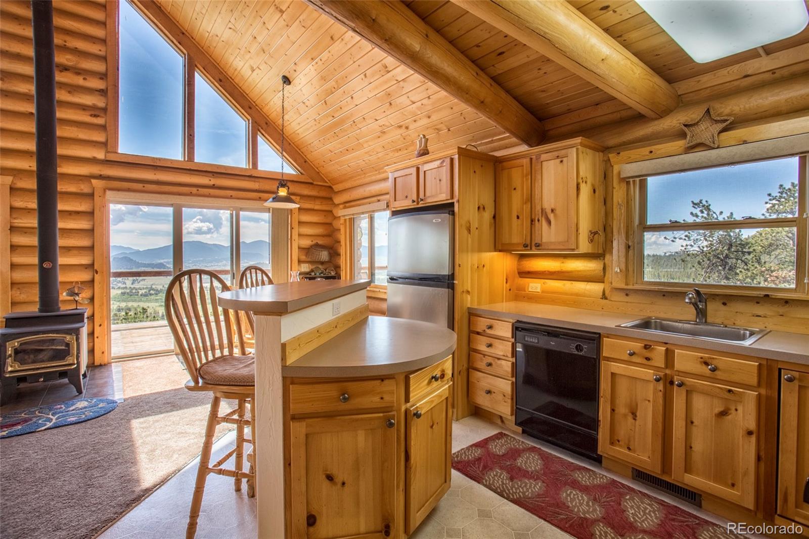 144 Red Cloud Road Como, CO 80456 - Photo 5 of 34 a kitchen with granite countertop a sink a stove and cabinets