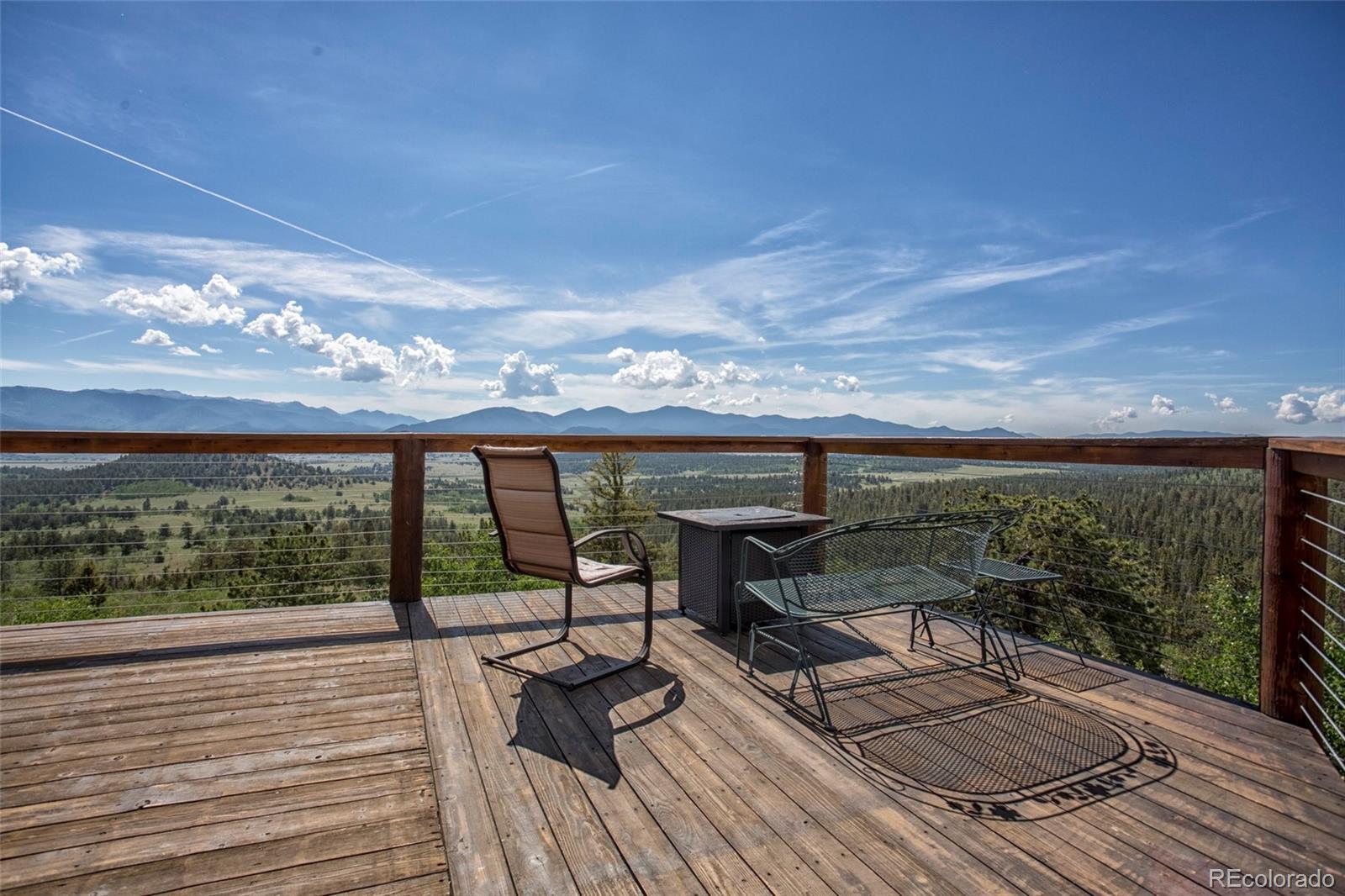 144 Red Cloud Road Como, CO 80456 - Photo 7 of 34 a view of a balcony with chairs and wooden floor