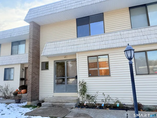 a view of a brick house with many windows