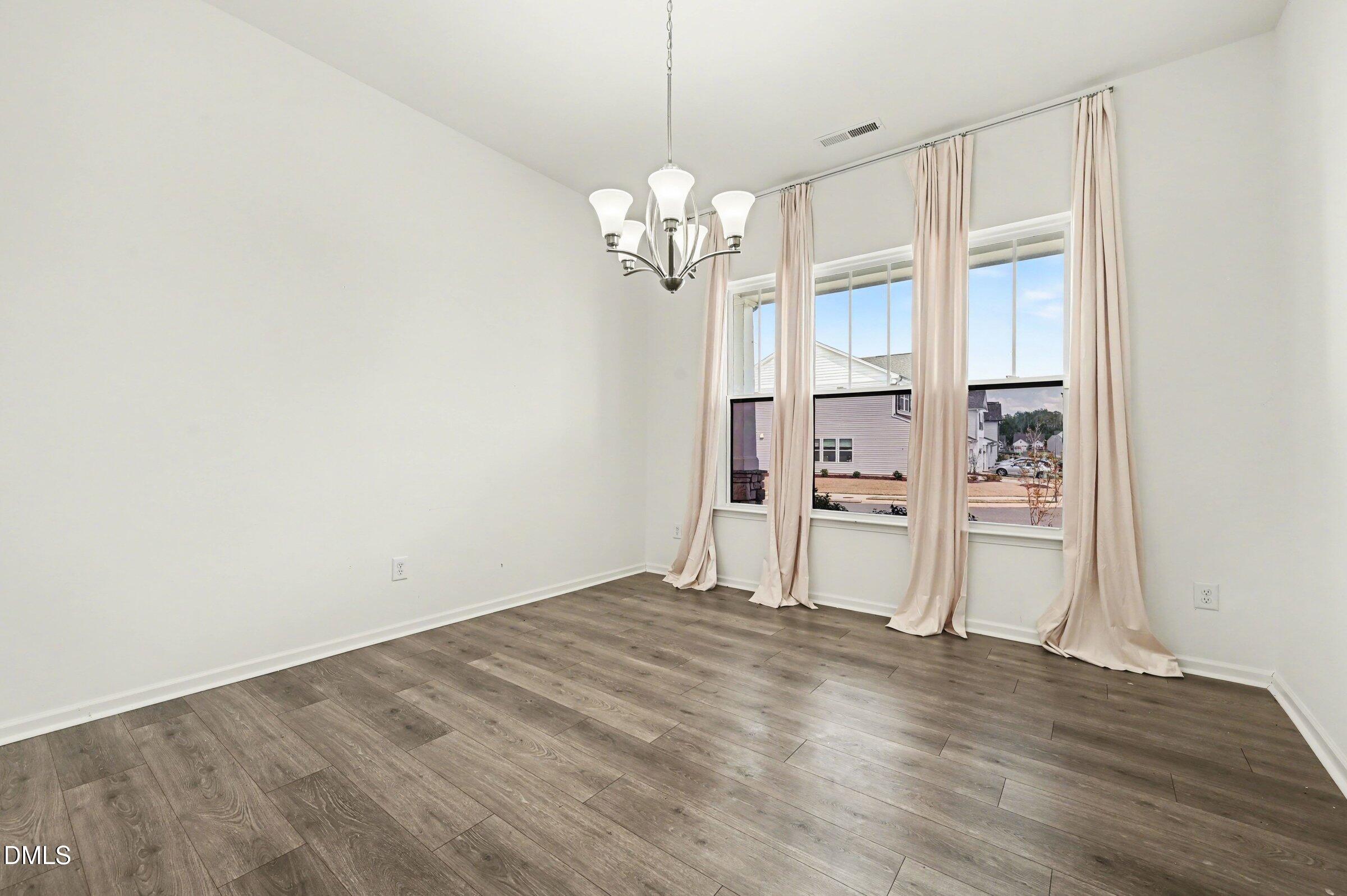 7015 Grainfield Road Mebane, NC 27302 - Photo 6 of 42 a view of a chandelier fan and wooden floor