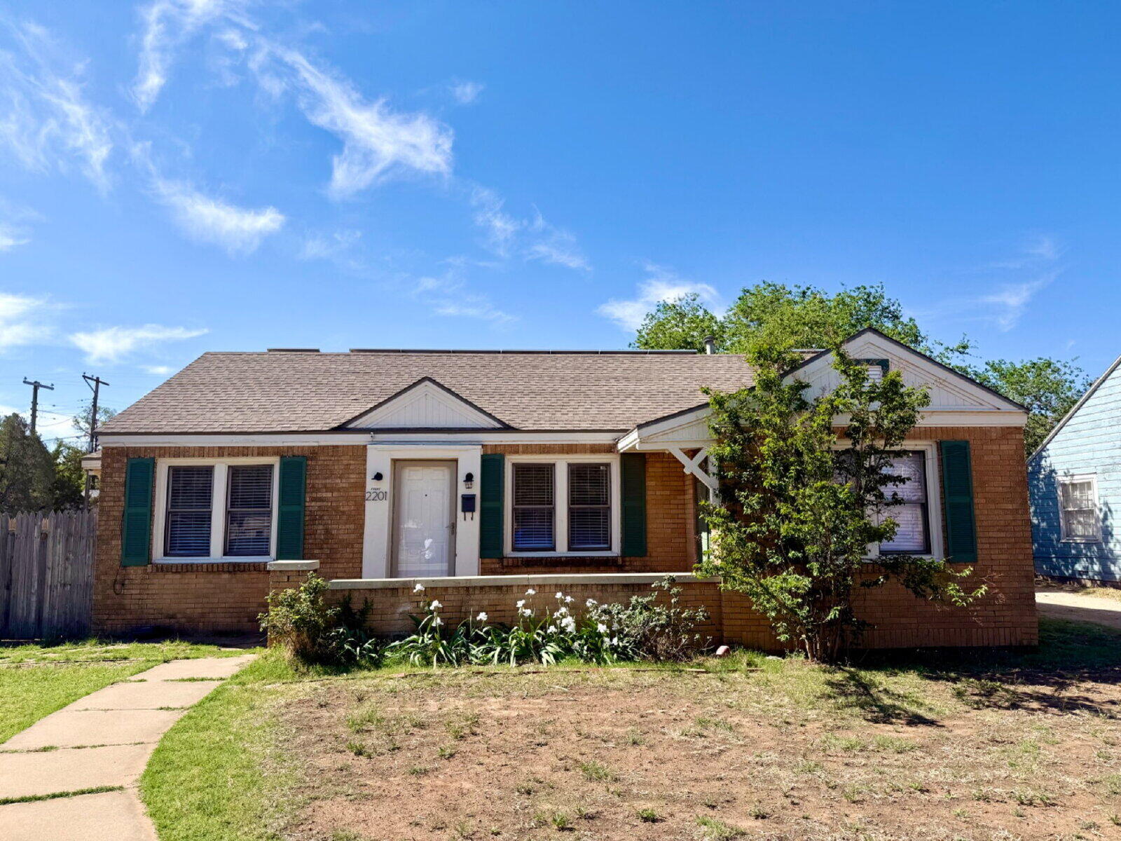 2201 28th Street, Unit FRONT Lubbock, TX 79411 - Photo 1 of 23 a front view of a house with a garden