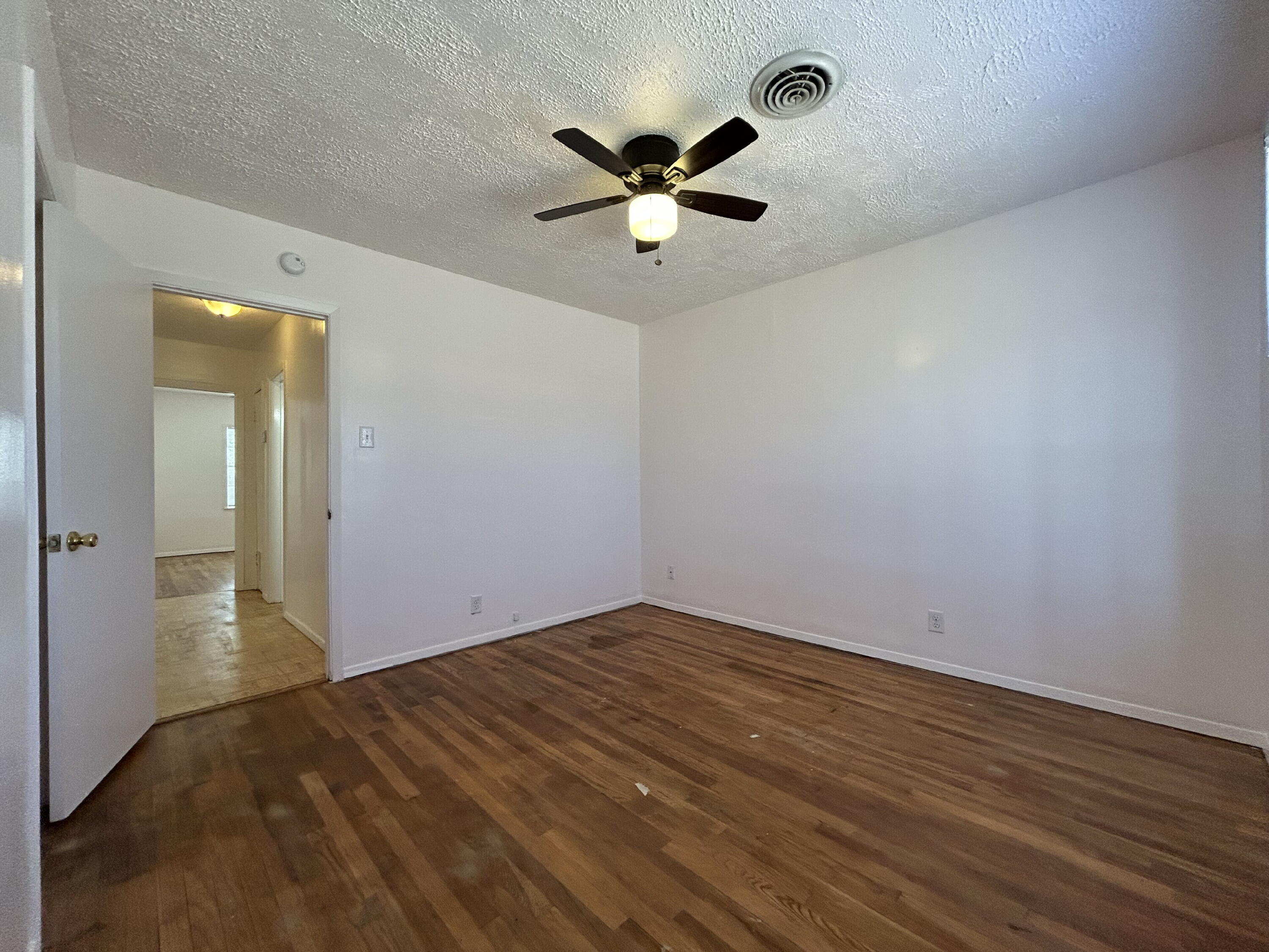 2201 28th Street, Unit FRONT Lubbock, TX 79411 - Photo 14 of 23 a view of empty room with wooden floor