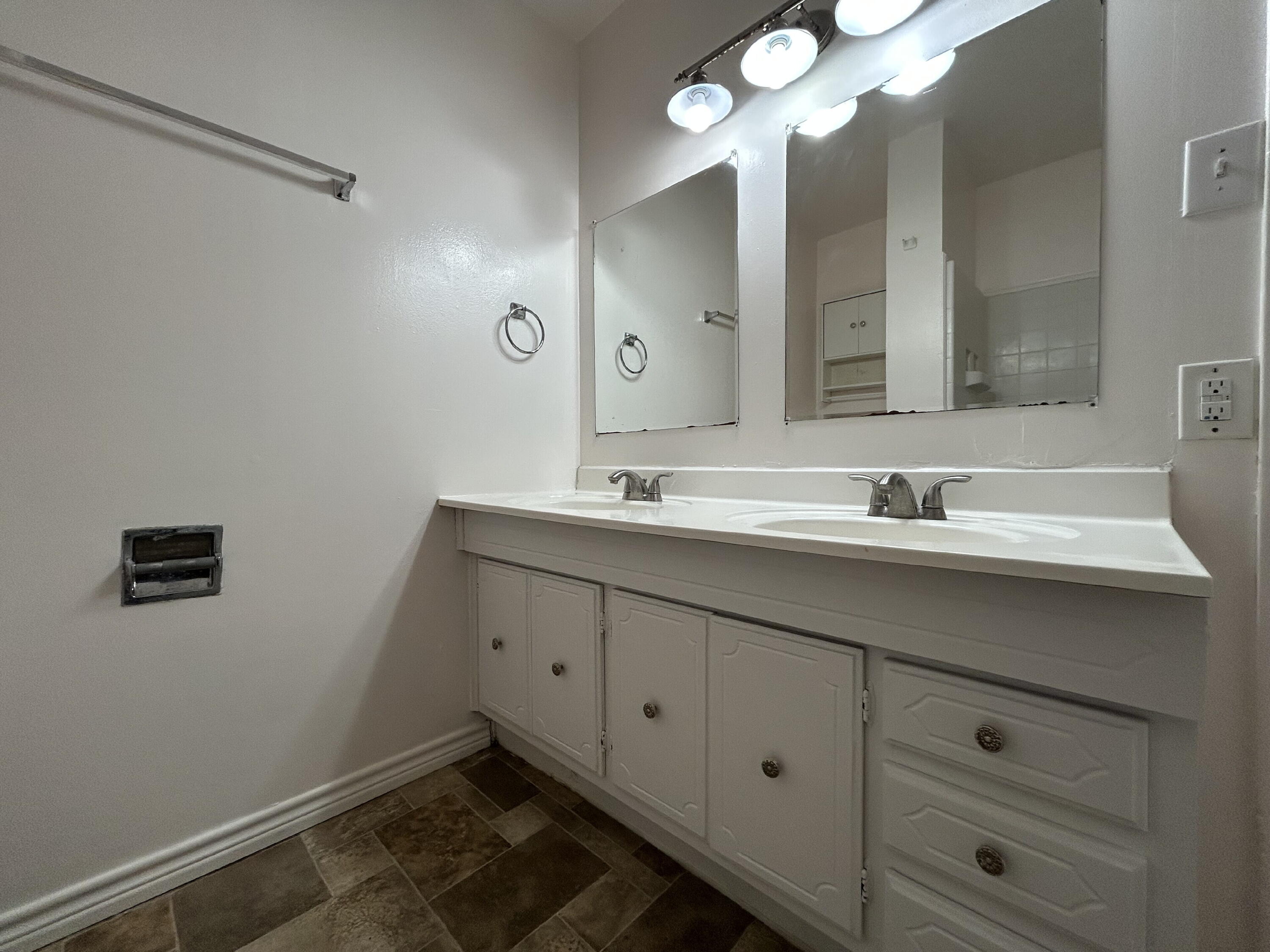2201 28th Street, Unit FRONT Lubbock, TX 79411 - Photo 16 of 23 a bathroom with a sink vanity and mirror