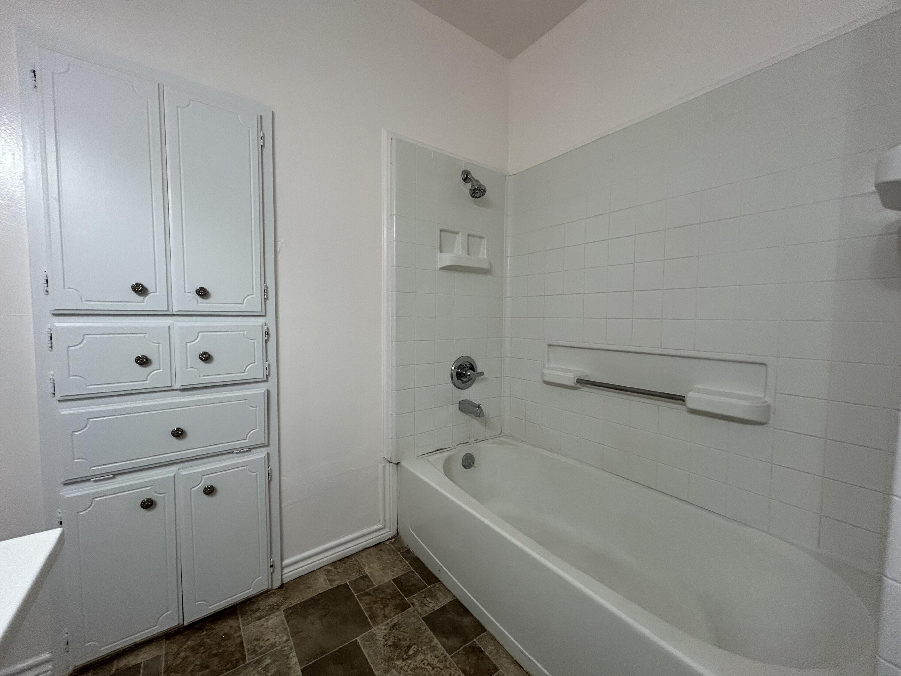 2201 28th Street, Unit FRONT Lubbock, TX 79411 - Photo 17 of 23 a bathroom with a bathtub