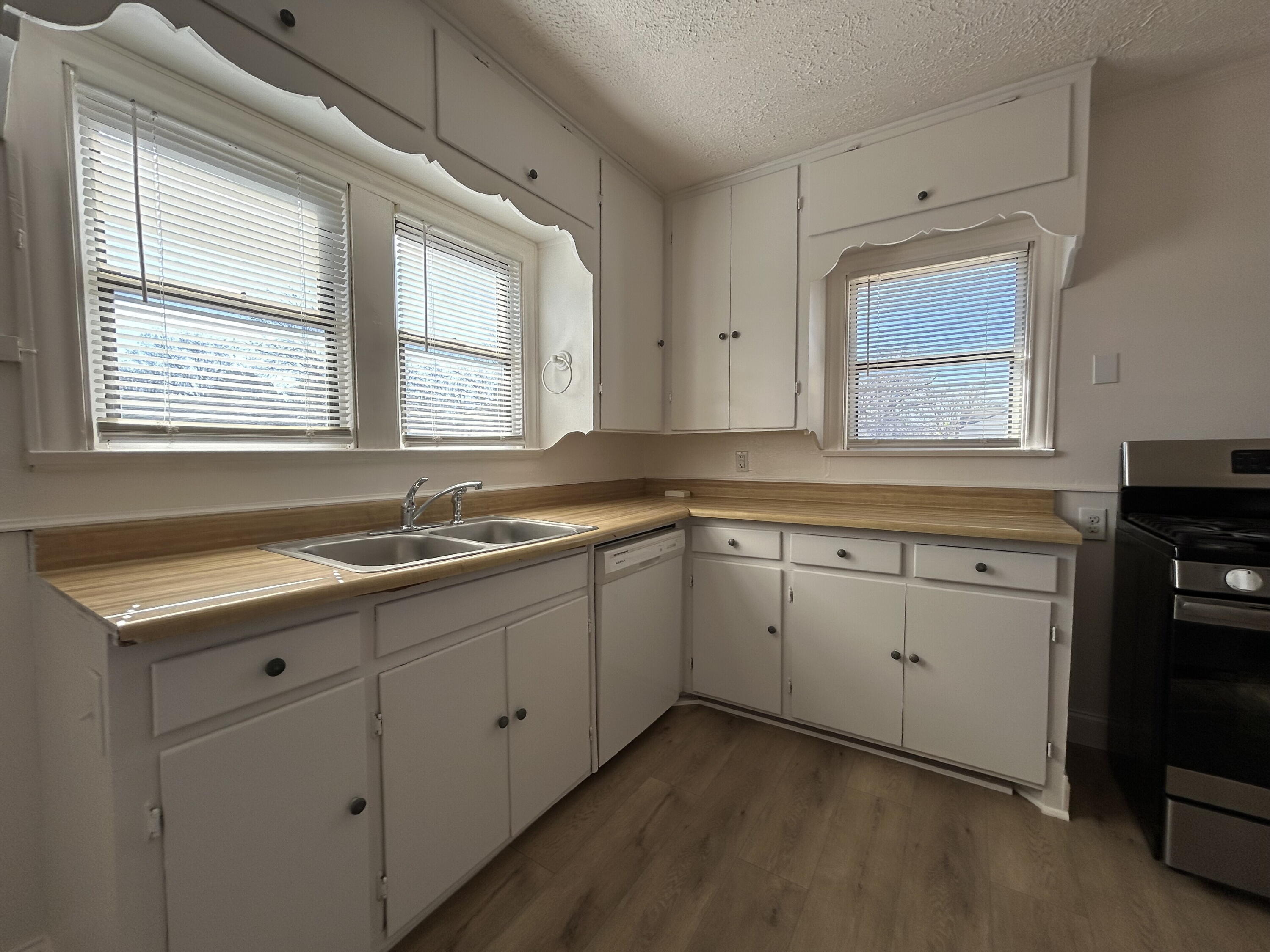 2201 28th Street, Unit FRONT Lubbock, TX 79411 - Photo 10 of 23 a kitchen with sink cabinets and window