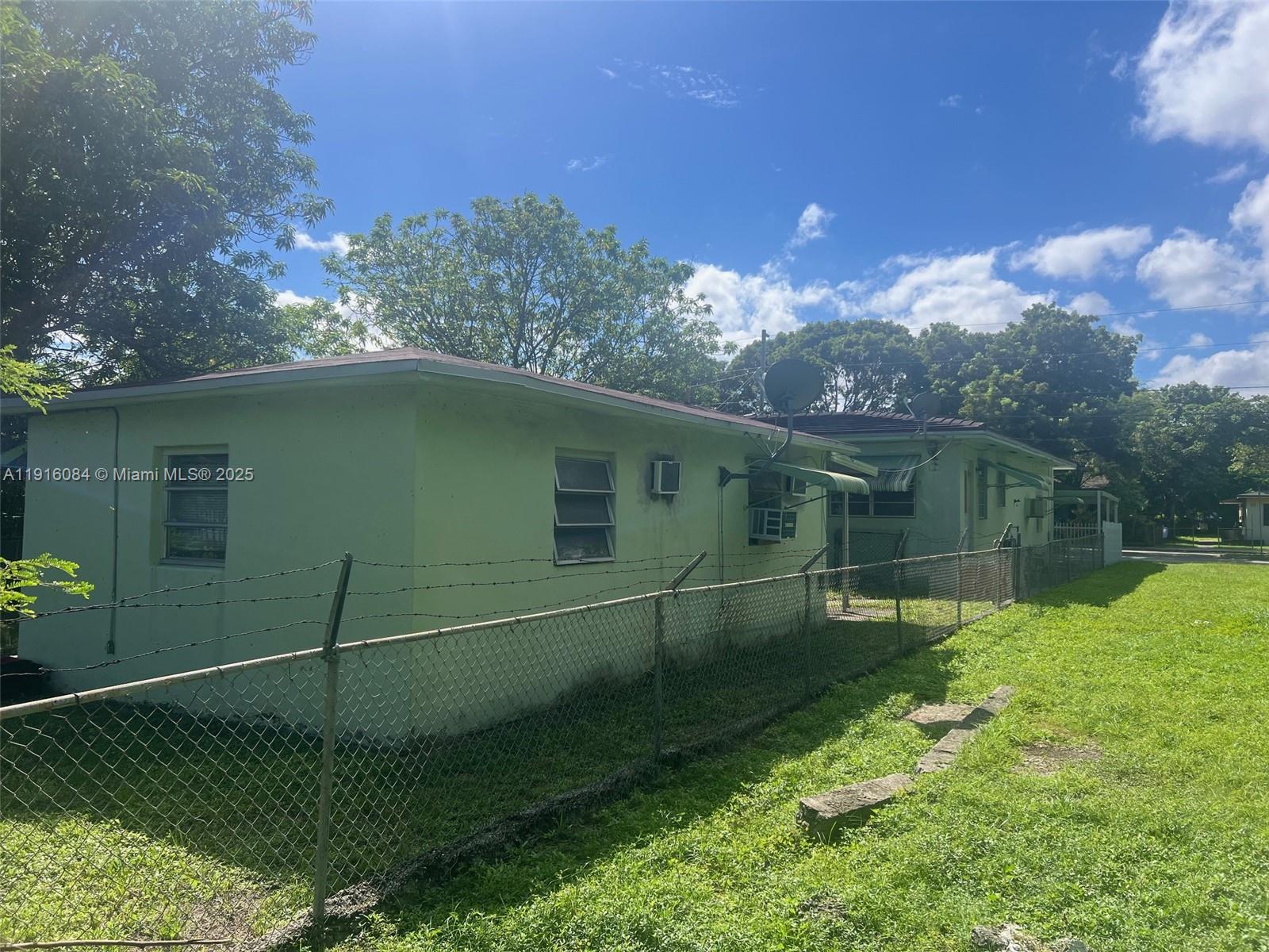 4751 Northwest 15th Avenue Miami, FL 33142 - Photo 7 of 10 a backyard of a house with lots of green space