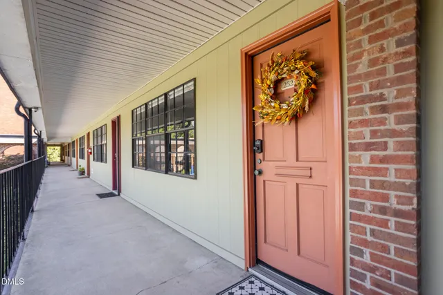 a view of a hallway with wooden walls and windows