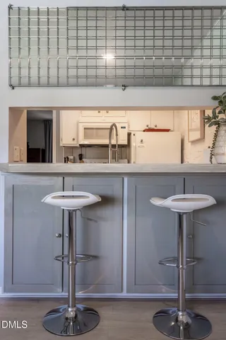 a view of a kitchen with fridge and sink
