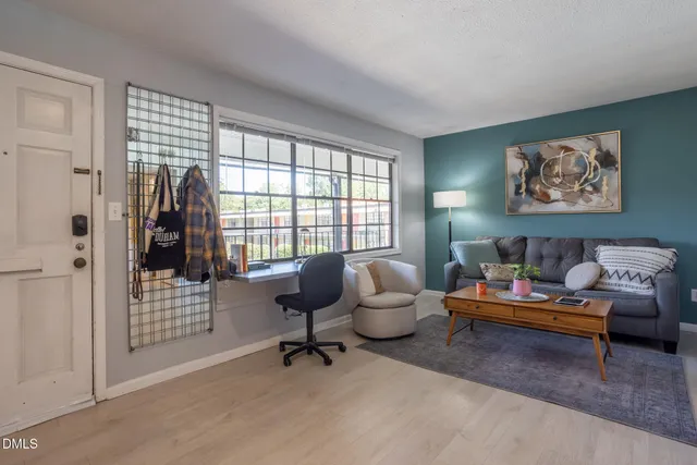 a living room with furniture rug and window