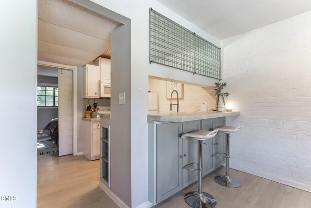 a kitchen with a sink and chandelier