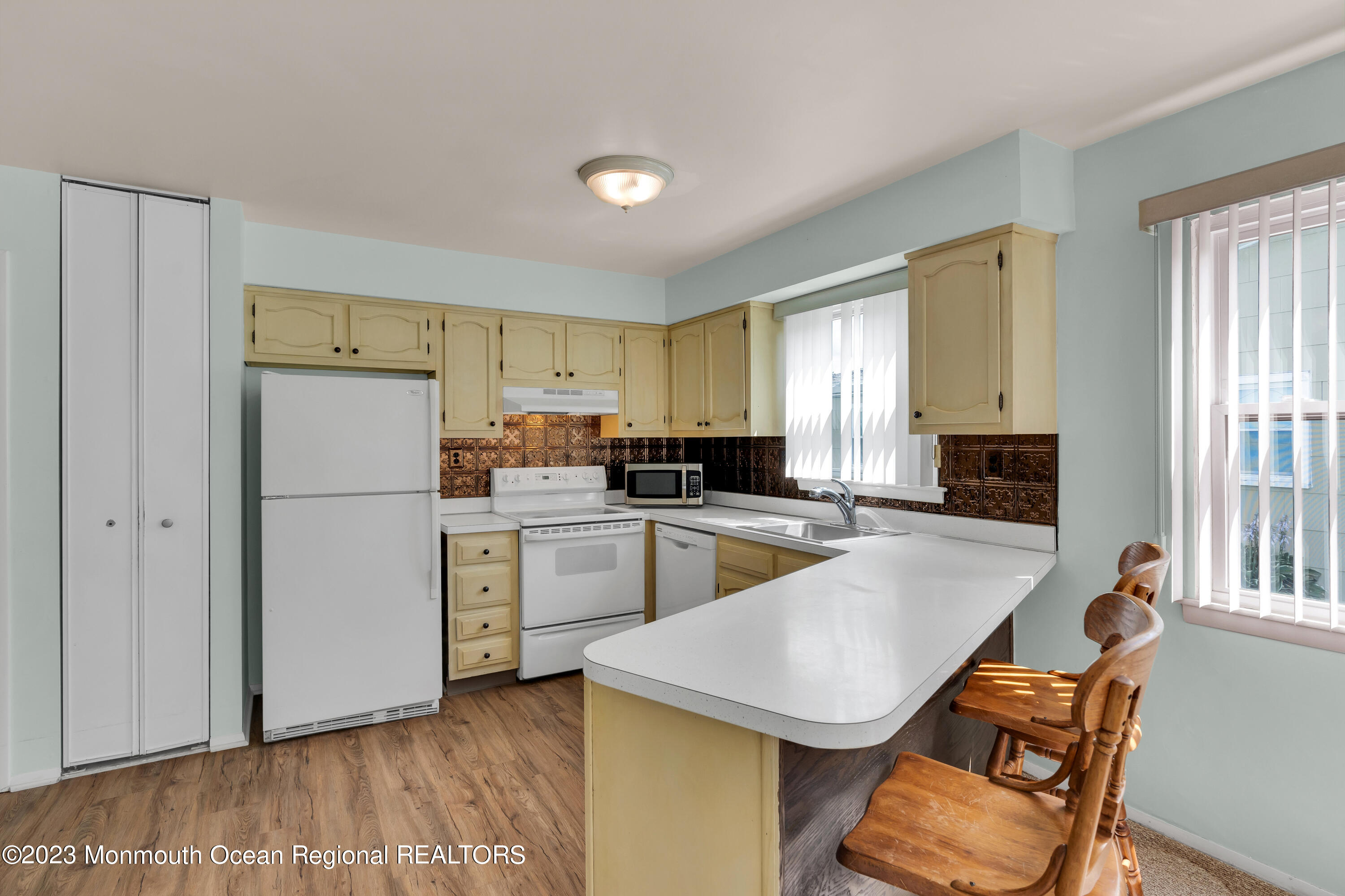 21 Blake Circle Brick, NJ 08724 - Photo 12 of 23 a kitchen with a refrigerator a stove a sink dishwasher and a refrigerator with wooden floor