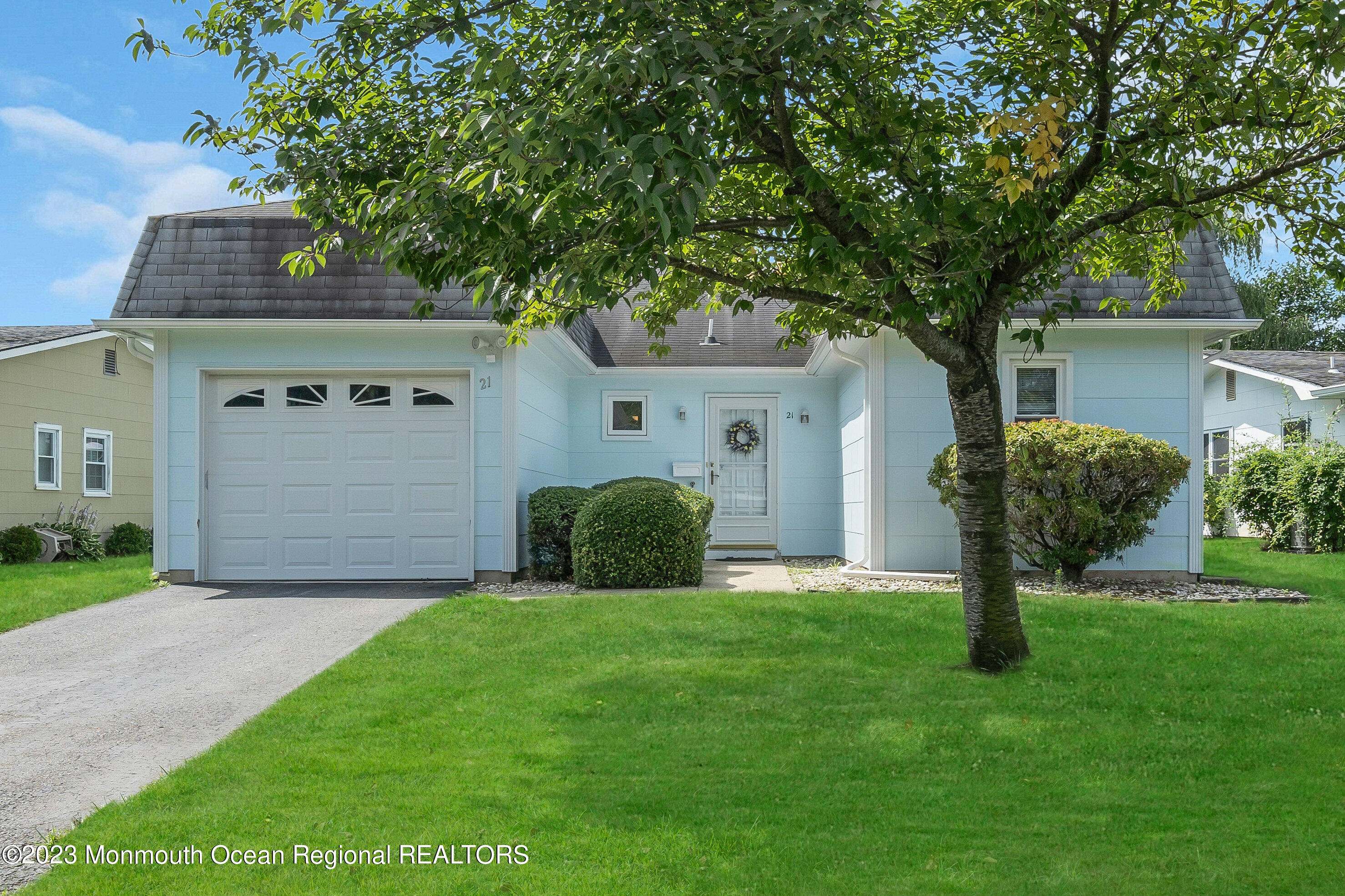 21 Blake Circle Brick, NJ 08724 - Photo 4 of 23 a front view of a house with a garden and yard