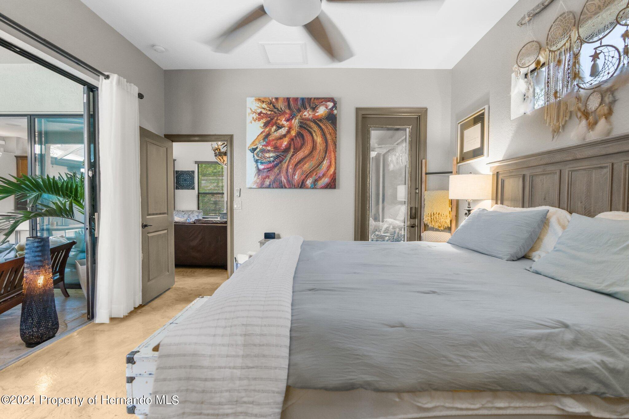 8075 Delaware Weeki Wachee, FL 34607 - Photo 8 of 96 a bedroom with a large bed and a potted plant