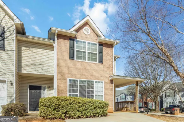 a front view of a building with a garden
