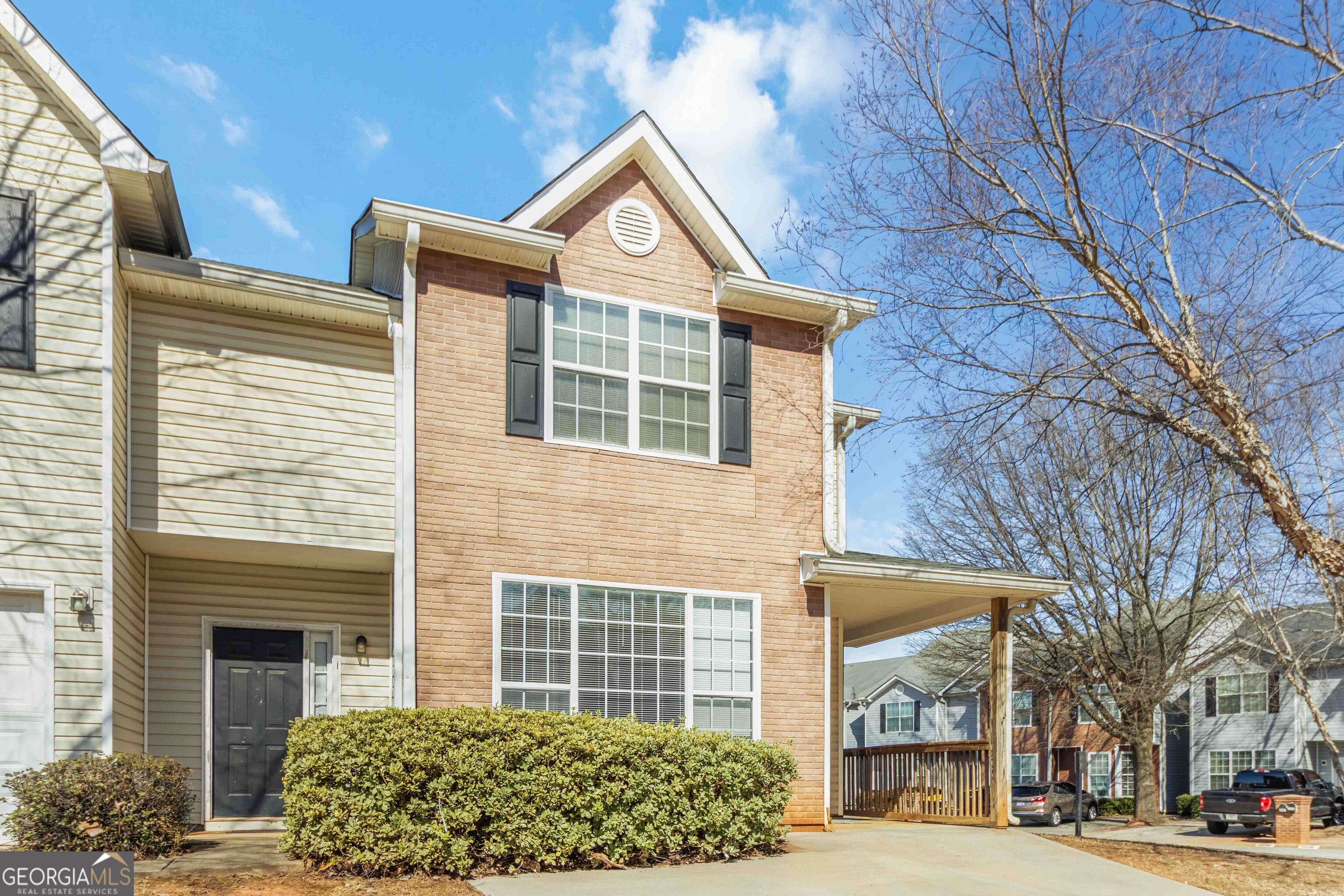 a front view of a building with a garden