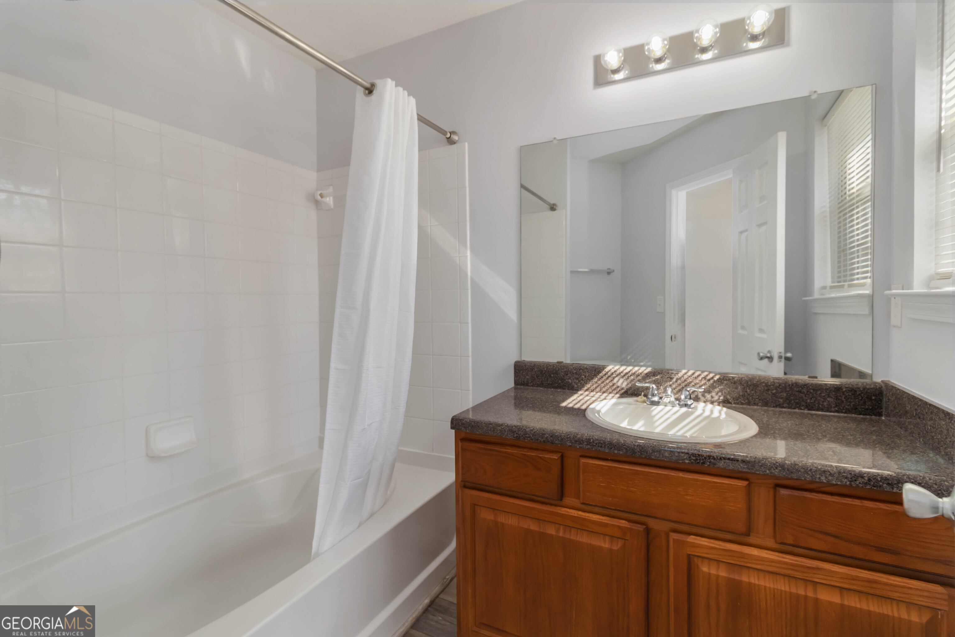 11307 Michelle Way Hampton, GA 30228 - Photo 16 of 30 a bathroom with a granite countertop sink and a mirror
