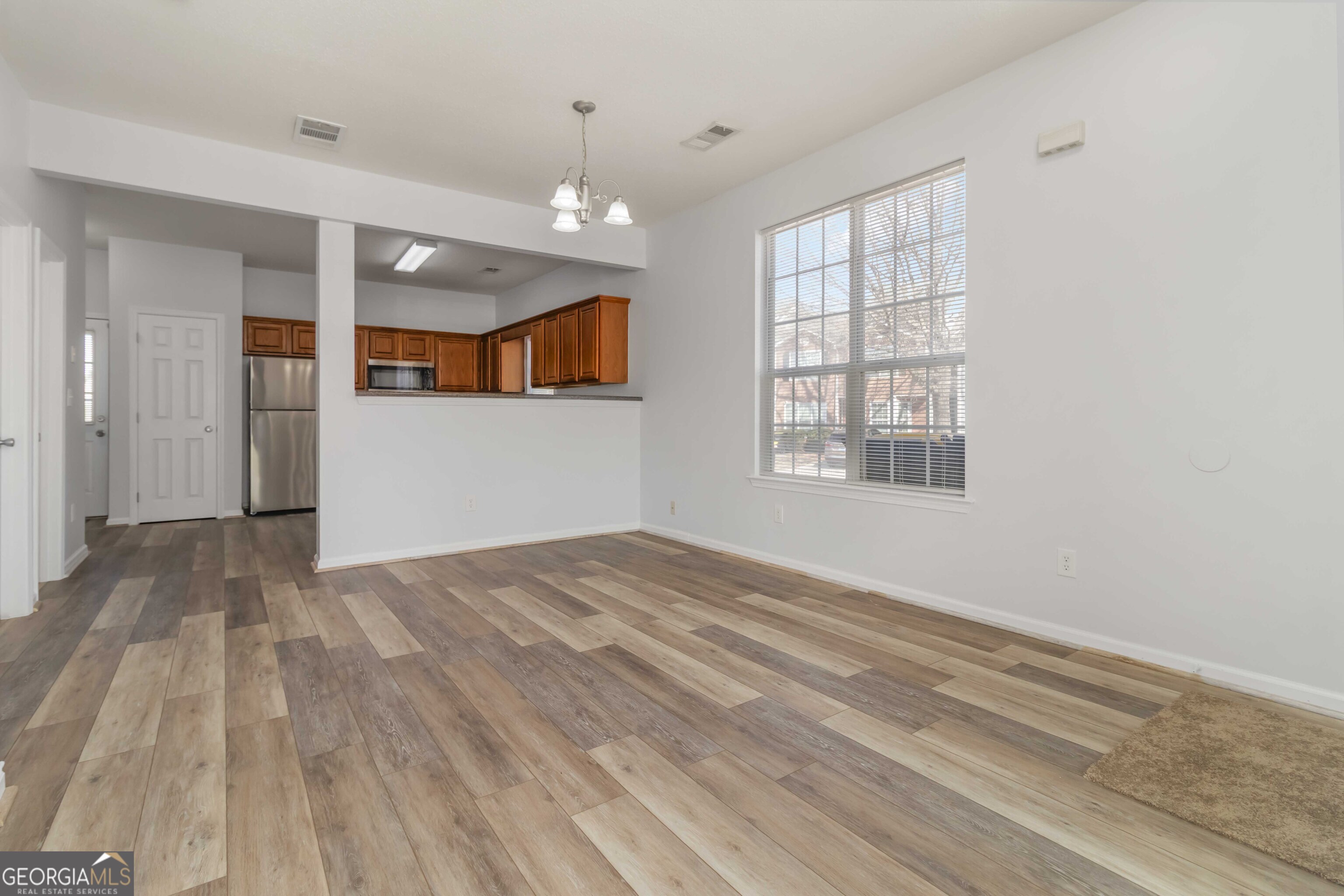 11307 Michelle Way Hampton, GA 30228 - Photo 24 of 30 a view of empty room with wooden floor and fan