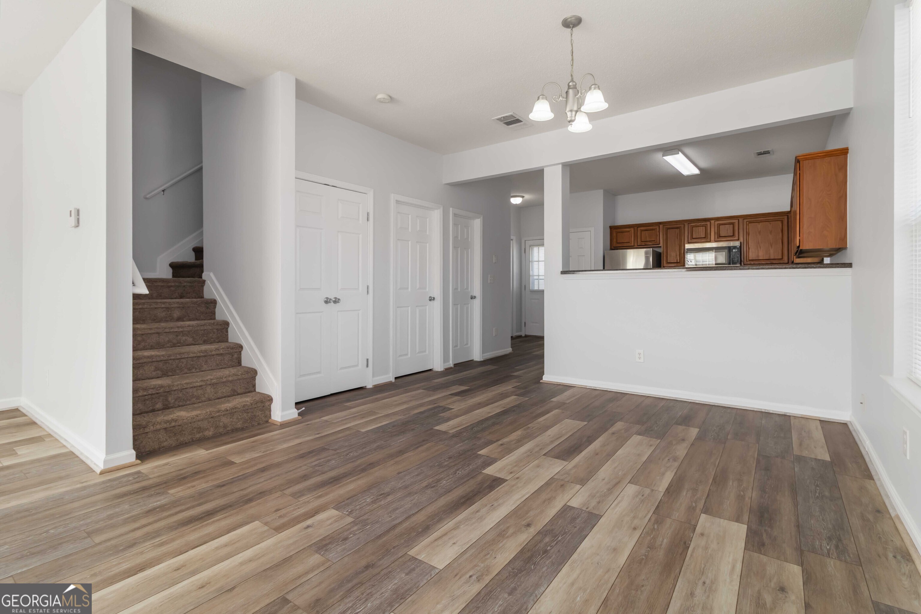 11307 Michelle Way Hampton, GA 30228 - Photo 6 of 30 a view of a room with wooden floor and staircase