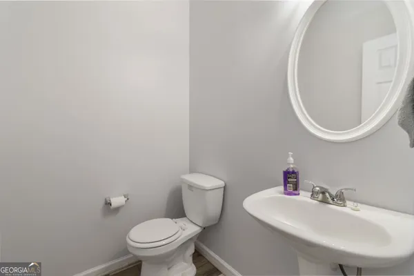 a bathroom with a toilet a sink and a mirror