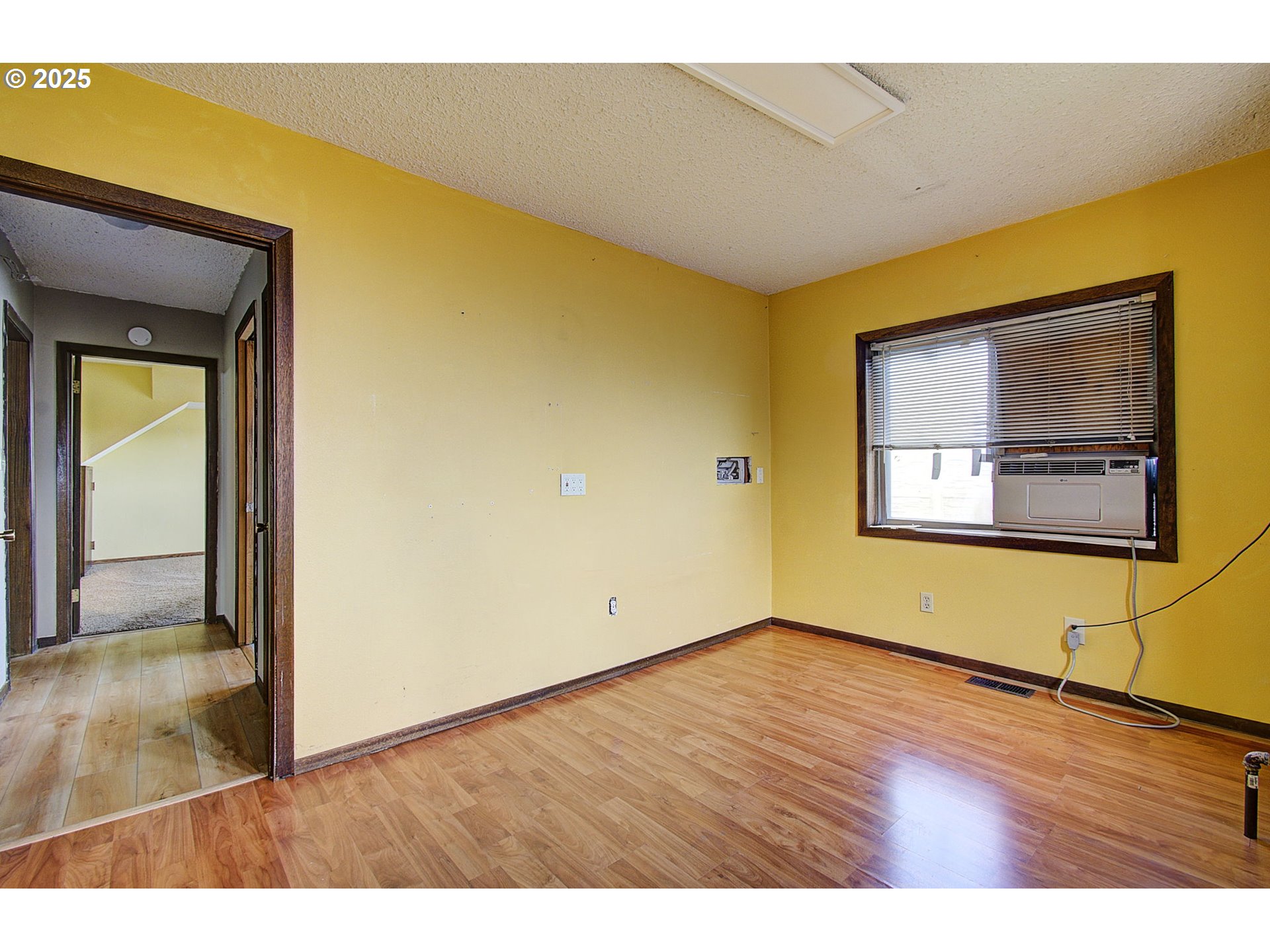 8400 Cason Road Gladstone, OR 97027 - Photo 14 of 35 a view of an empty room with wooden floor and a window