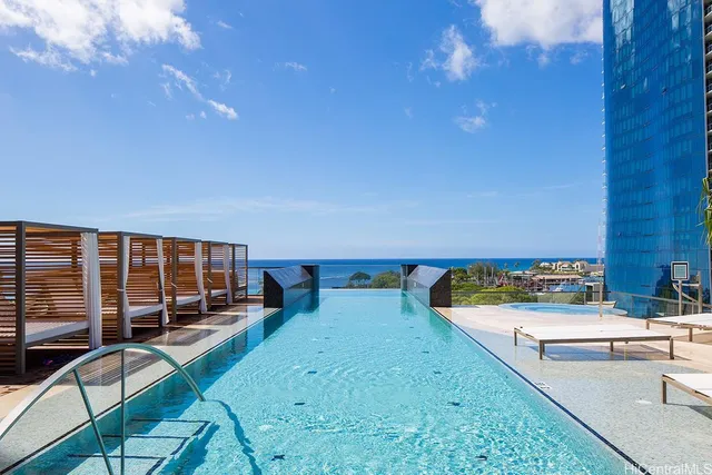 swimming pool view with a seating space