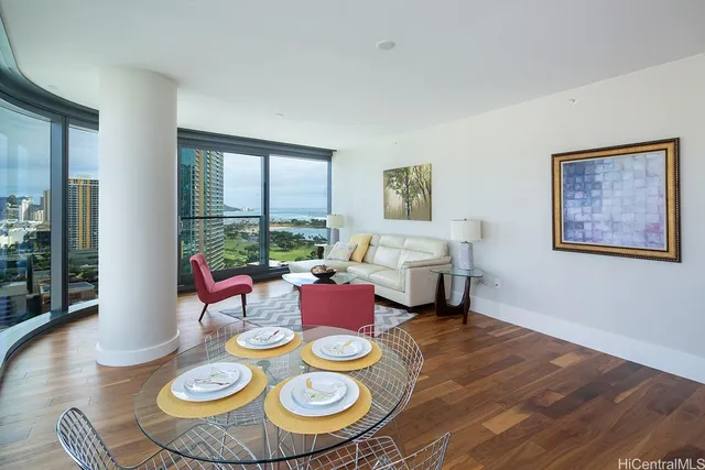 a dining room with furniture a large window and wooden floor