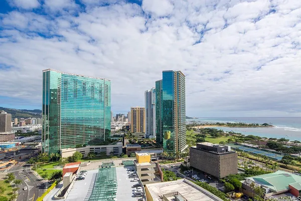 a view of terrace with lawn chairs and iron fence
