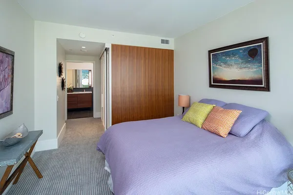 a bedroom with a bed and a couch