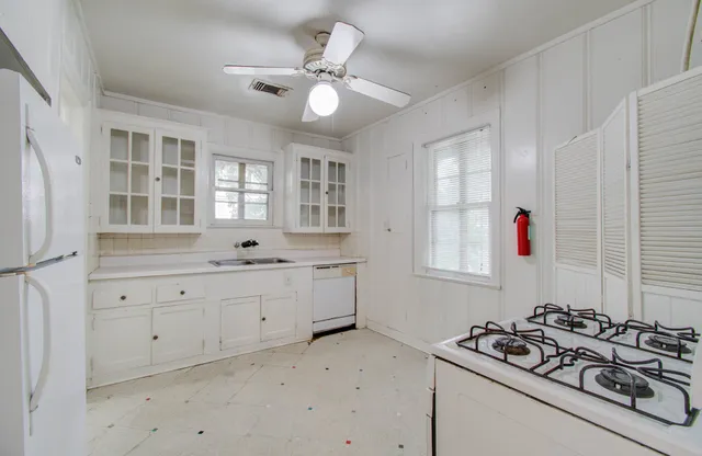a bathroom with a sink vanity granite tub and shower