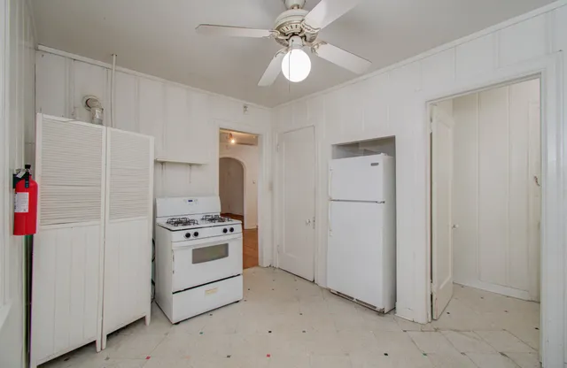 a kitchen with a refrigerator and a stove