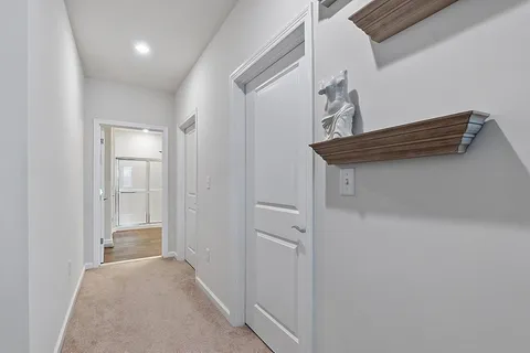 a view of hallway with stairs and wooden floor