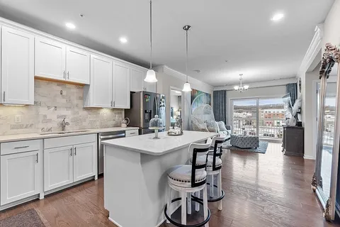 a kitchen with counter top space a sink appliances and cabinets