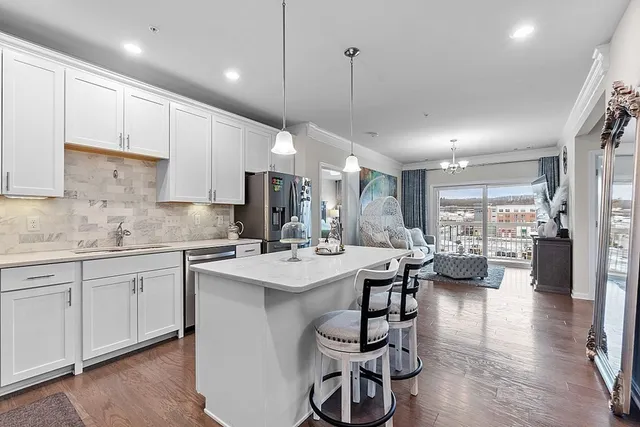 a kitchen with counter top space a sink appliances and cabinets
