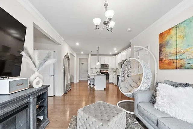 a very nice looking dining room with furniture a rug and wooden floor