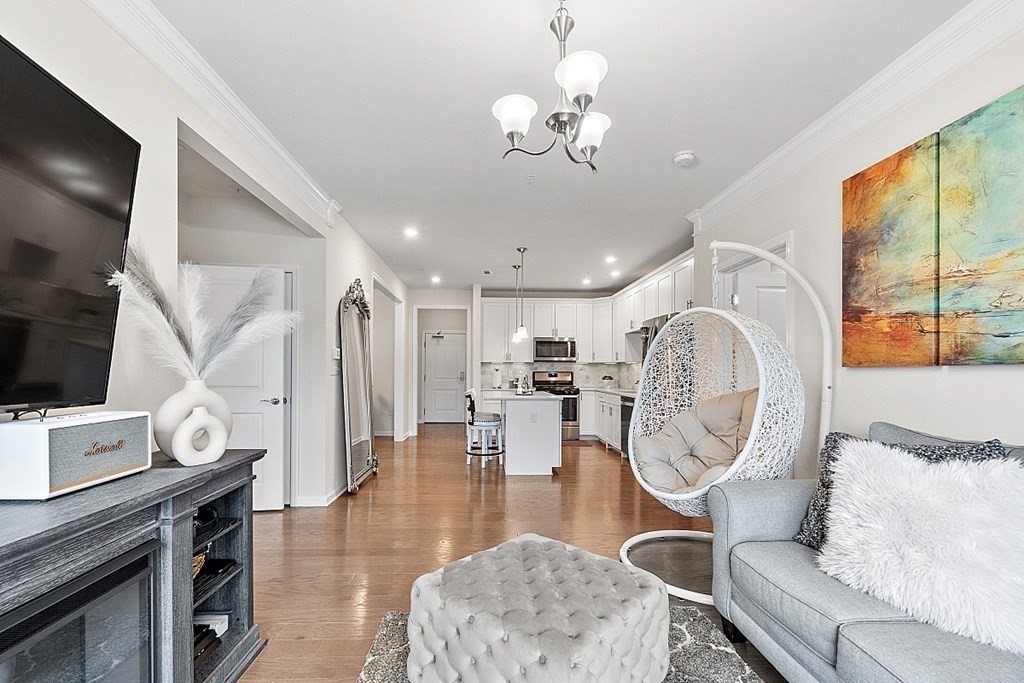 120 University Avenue, Unit 2308 Westwood, MA 02090 - Photo 3 of 20 a very nice looking dining room with furniture a rug and wooden floor