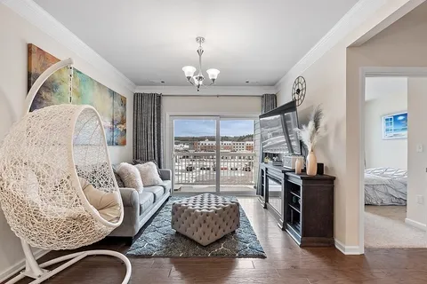 a living room with furniture or couch and a chandelier