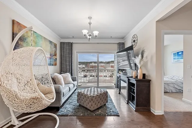 a living room with furniture or couch and a chandelier