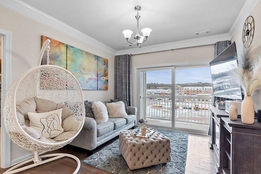 120 University Avenue, Unit 2308 Westwood, MA 02090 - Photo 6 of 20 a living room with furniture and a large window