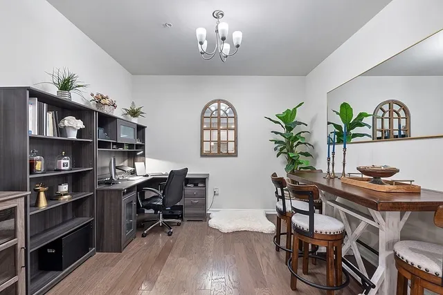 a view of a workspace with furniture and wooden floor
