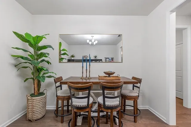 a dining room with furniture and a potted plant