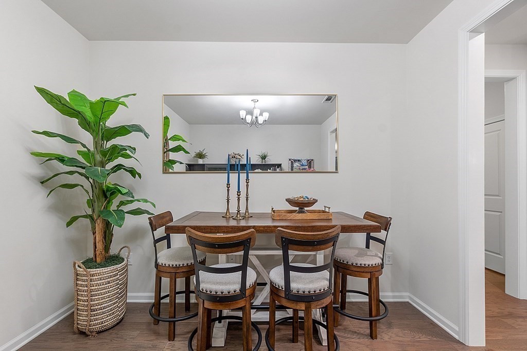 120 University Avenue, Unit 2308 Westwood, MA 02090 - Photo 9 of 20 a dining room with furniture and a potted plant