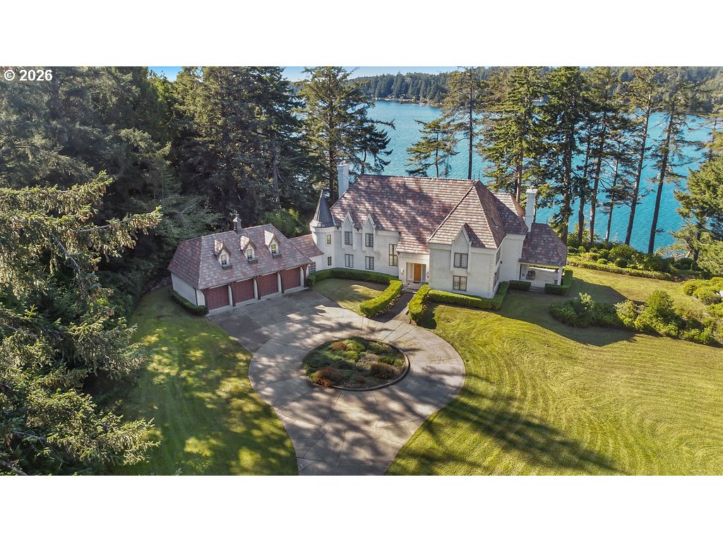 5255 Salal Court Florence, OR 97439 - Photo 1 of 46 a aerial view of a house with swimming pool and mountains