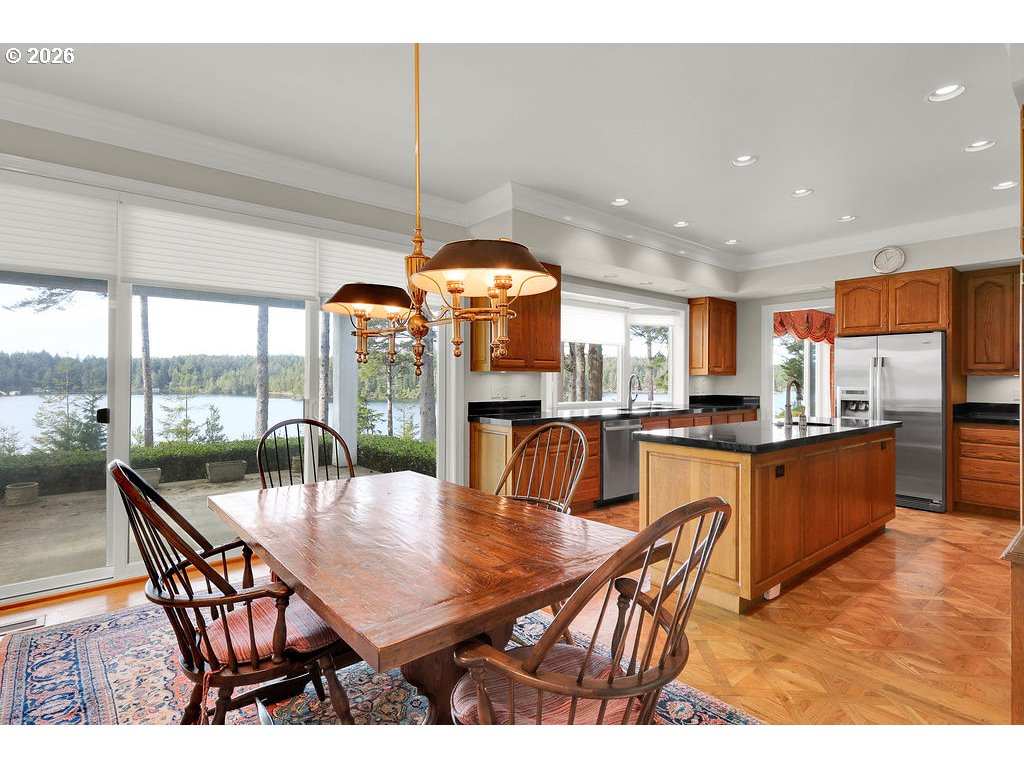 5255 Salal Court Florence, OR 97439 - Photo 14 of 46 a dining hall with stainless steel appliances a dining table and chairs