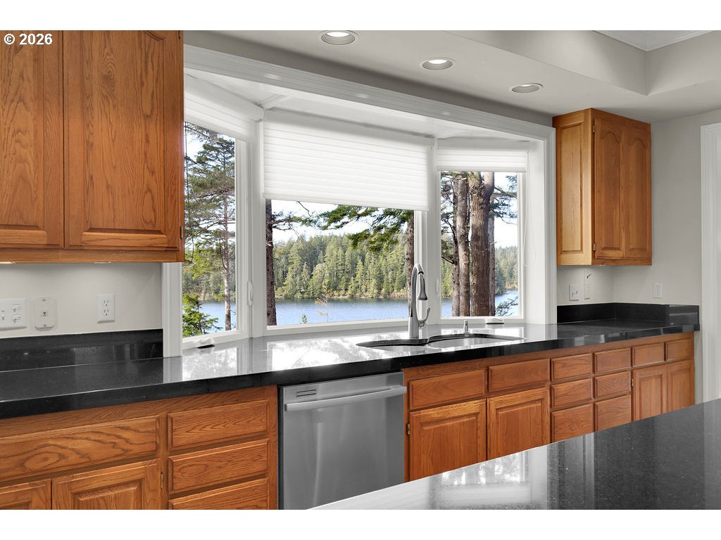 5255 Salal Court Florence, OR 97439 - Photo 10 of 46 a kitchen with stainless steel appliances granite countertop a sink a counter space and cabinets